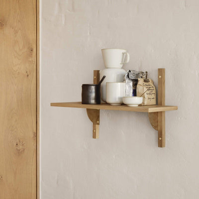 Ferm Living Sector shelf, single narrow in natural oak with polished brass brackets. Ideal kitchen storage. Available from someday designs
