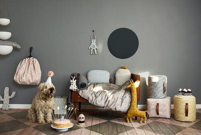 Scandinavian styled nursery room with modern cushions, cuddle toys and textiles.