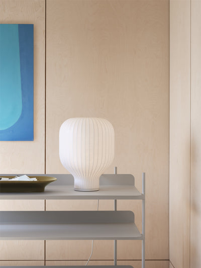 Strand Table Lamp by Muuto lifestyle image on shelving unit.