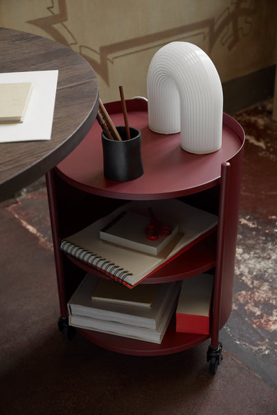 ferm LIVING Eve Storage table lifestyle image with Vuelta Lamp. Free UK delivery at someday designs. #colour_mahogany-red