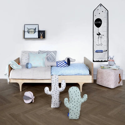 the quirky cactus cushions by OYOY take centre stage in this Scandinavian inspired childrens room setting