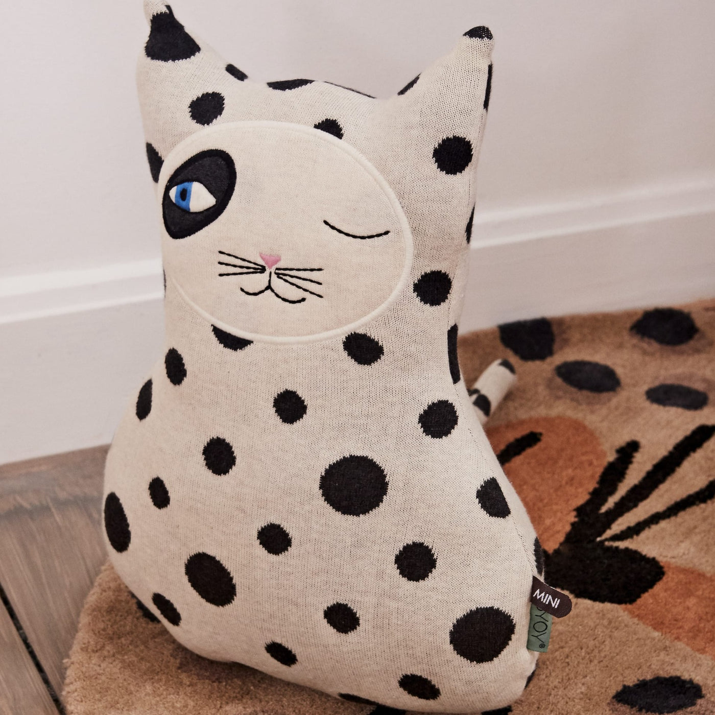 the cool cat zorro cushion by OYOY has a stylish monochrome spotty print and distinctive eye detailing.