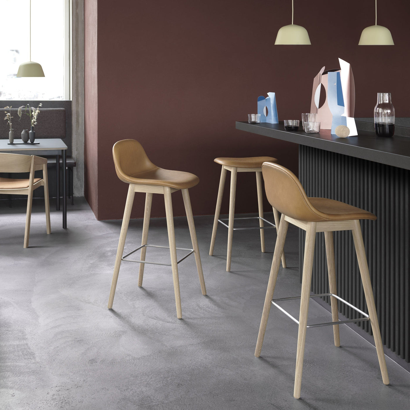 muuto fiber bar stool wood base in bar setting available at someday designs. #colour_cognac-refine-leather