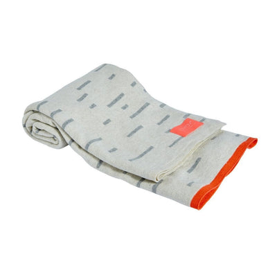 the smilla plaid blanket is a cosy and stylish knitted blanket - a must have accessory for babies and children. Picture here the off white and grey blanket with a fun neon orange piped detail and label.