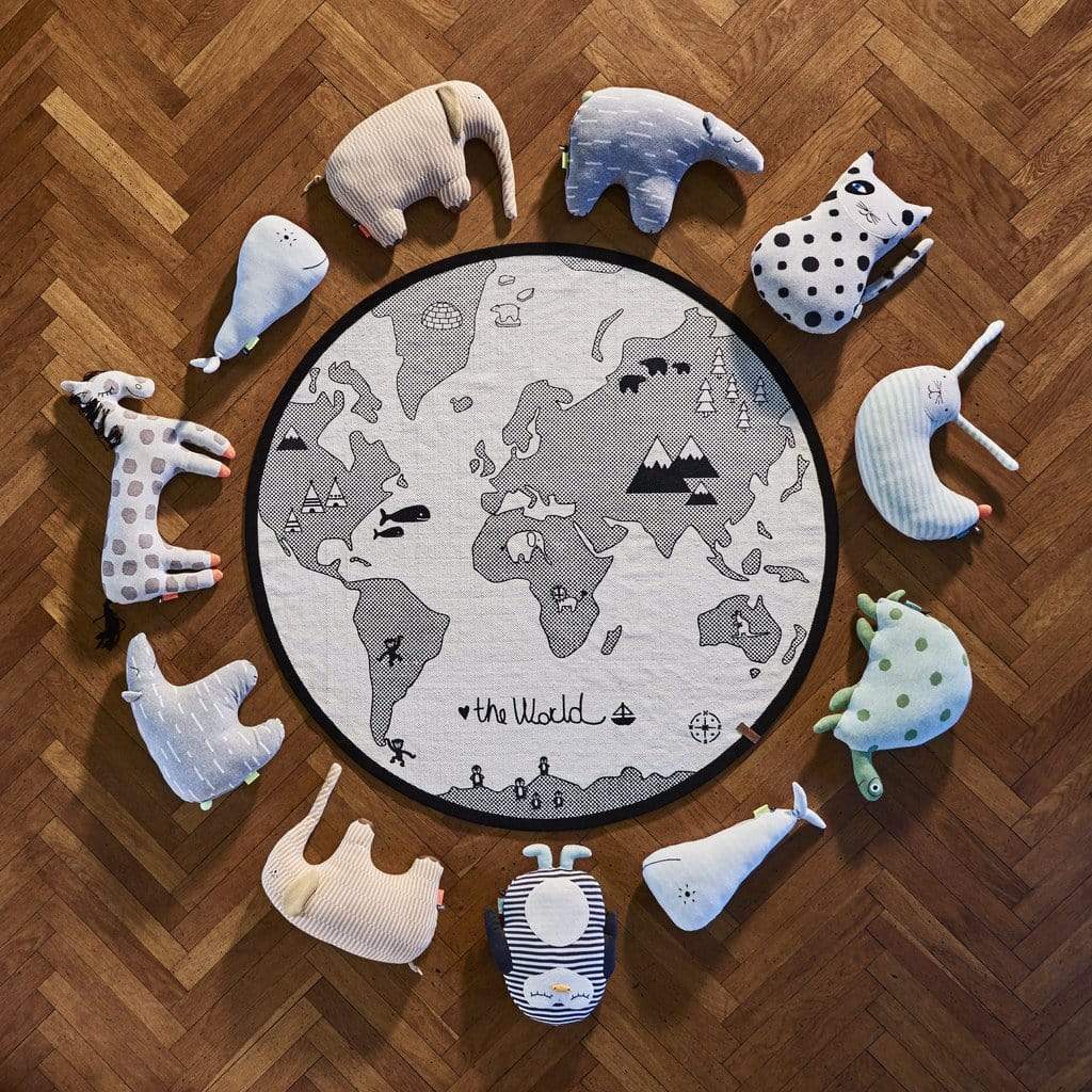 ariel view of the animal cushion collection from the mini range by danish design brand OYOY.  The animals sit in a circular display on parquet flooring surrounding the world map rug.